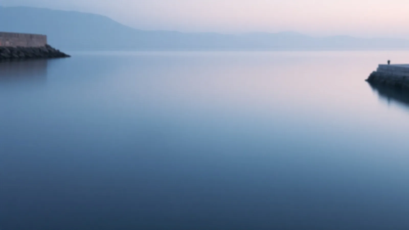 A calm sheltered harbour with still water and a stone breakwater at dawn, the FundsAnchor view of emergency loans online, $100 – $5,000